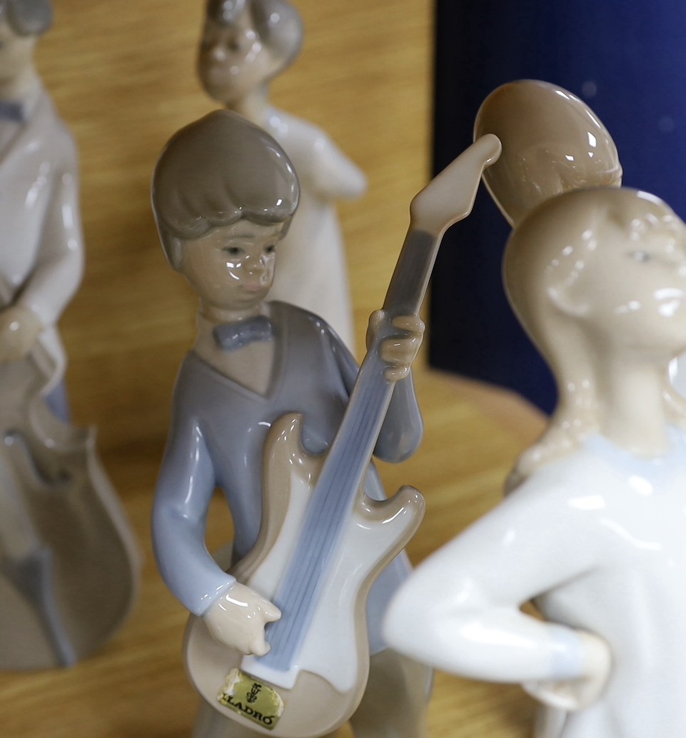 A Lladro collection: seven figures, five further damaged figures and a Lladro reference book